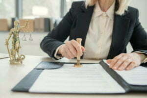 Female Lawyer Stamping Document 2021 09 24 03 43 51 Utc 300x200