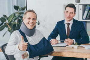 How to Get Workers Compensation in South Carolina Businessman Sitting At Table Wile Worker In Neck B 2022 02 05 03 37 18 Utc 1 300x200