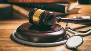 Get To Know North Carolina's Personal Injury Laws A judge gavel and a stethoscope on a wooden desk