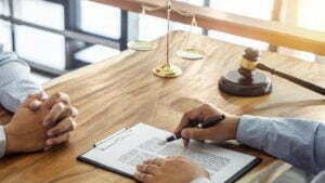Get To Know North Carolina's Personal Injury Laws Scales of justice on a desk during a legal consultation