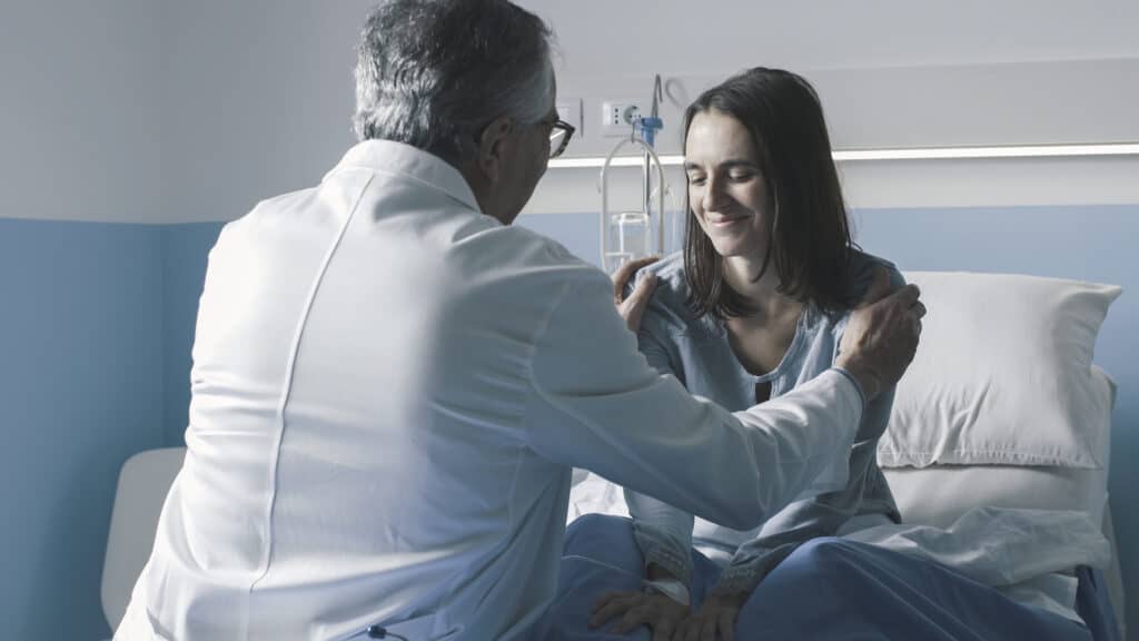a workers' comp doctor inspecting a patient.
