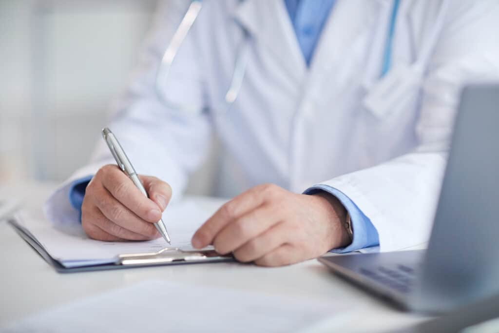 Do You Really Have to Give Your Adjuster Your Medical Records for the Last Ten Years? Doctor Filling Medical Card 2021 08 27 22 35 21 Utc 1024x683