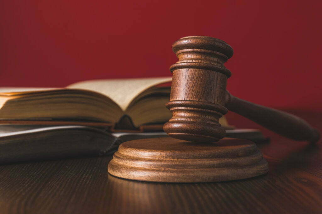 What Happens When My Workers' Compensation Adjuster Does Not Pay Me On Time? Opened Juridical Books With Hammer On Wooden Table 2022 11 03 03 42 50 Utc 1024x683