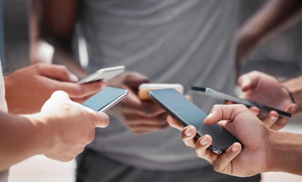 Can I Use Social Media During A Workers' Comp Case? Smartphone In Hand Friends Group And Internet Sha 2022 12 17 06 48 37 Utc 1024x616