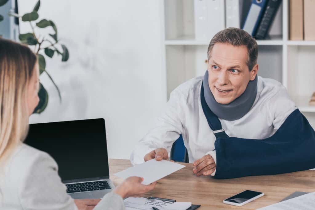 Worker In Neck Brace And Arm Bandage Sitting At Ta 2022 11 02 03 04 27 Utc 1024x683
