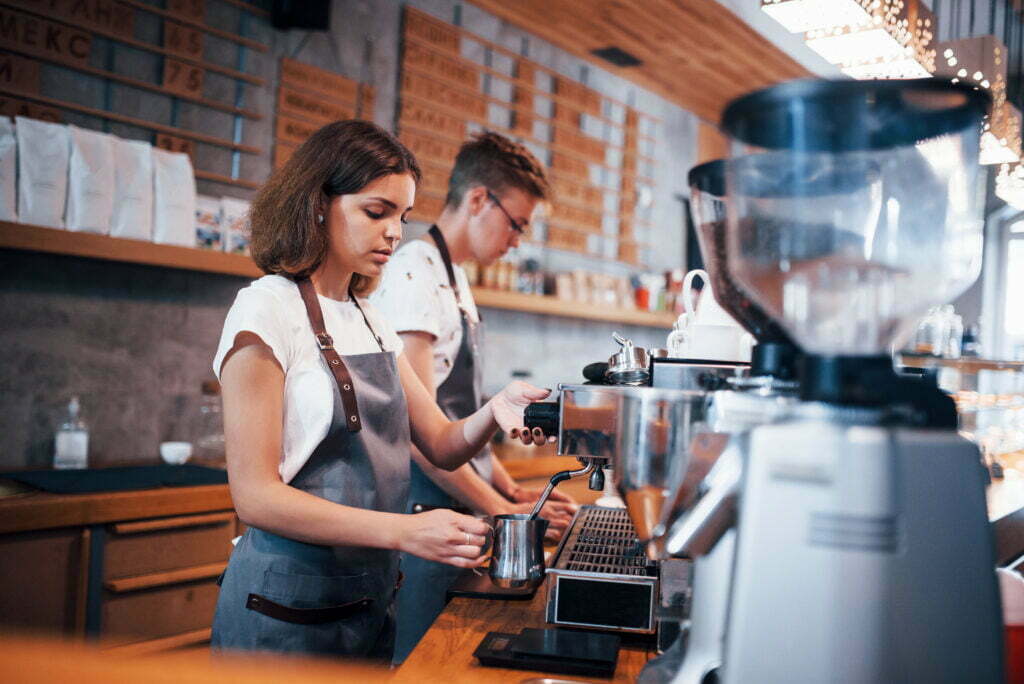 Is There Workers Compensation for Minors? Working Together Two Young Cafe Employees Indoors 2021 08 30 05 09 57 Utc 1 1024x684