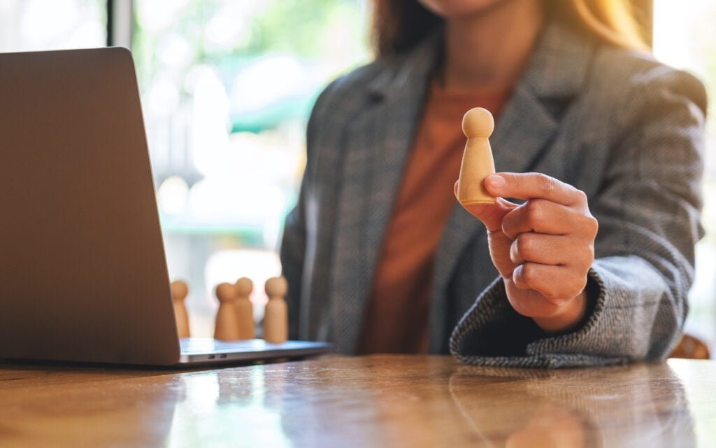 Workers' Compensation Laws Seem Designed to Protect Employers, Not Help Injured Workers. Businesswoman Leader Holding And Choosing Wooden P 2022 12 16 05 03 13 Utc 1024x640