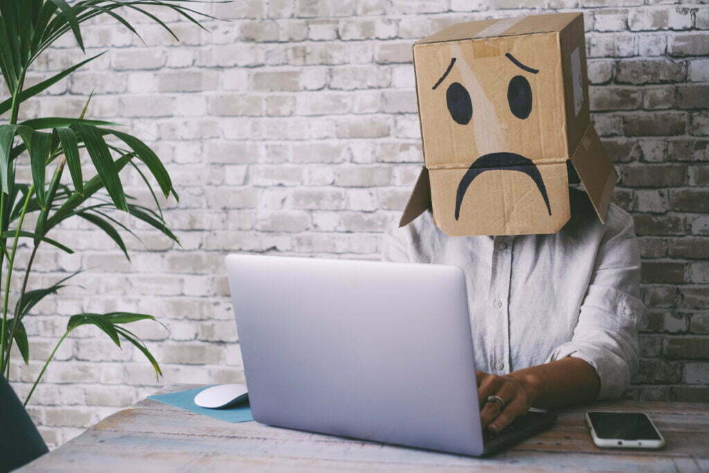 Sad People Working On Laptop Wearing Carton Box On 2022 04 08 16 41 32 Utc 1024x683