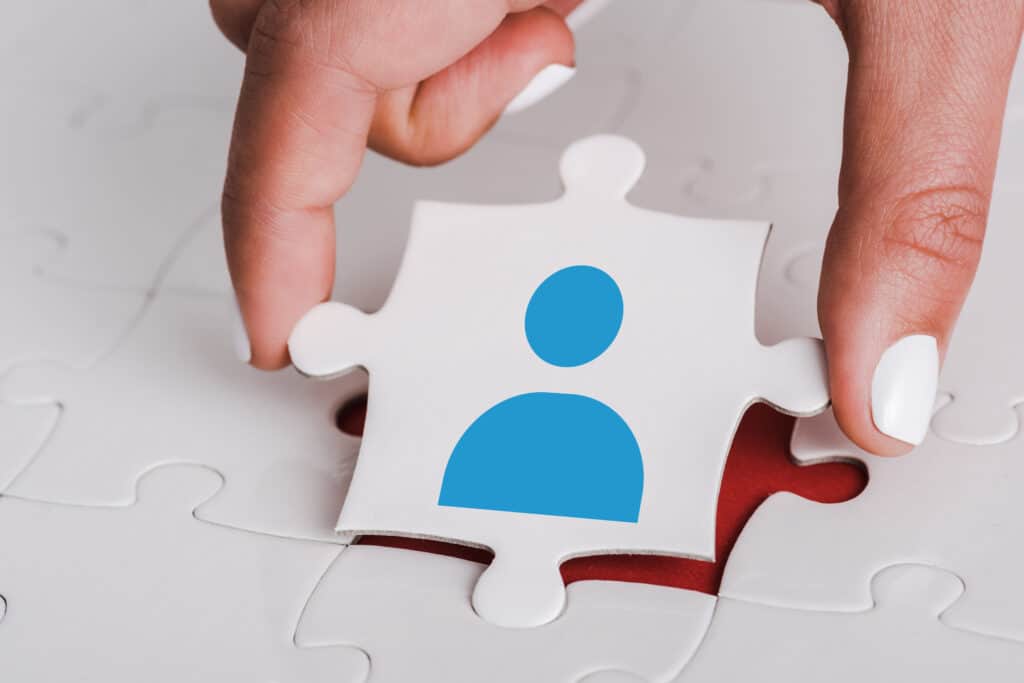 Using Vacation and Sick Time as Requirement for Workers' Comp Pay: Is It Legal? Close Up Of Woman Holding White Jigsaw With Blue H 2022 12 16 20 29 08 Utc 1 1024x683